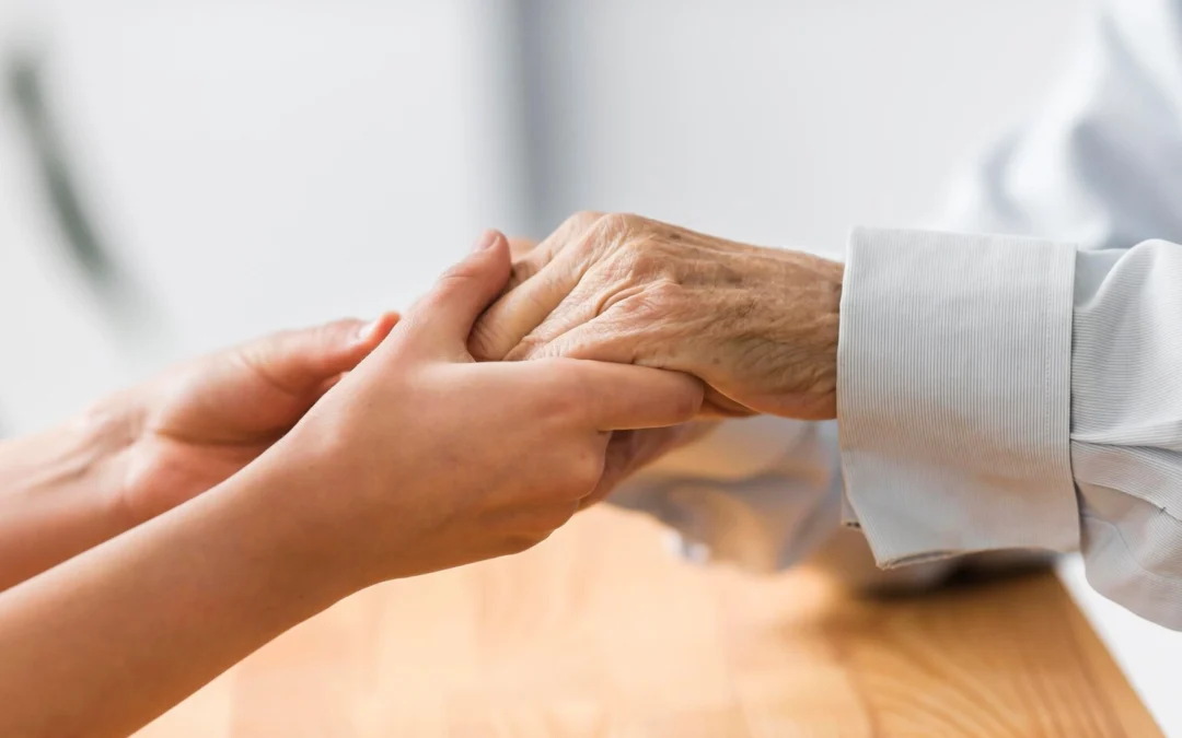 nurse-holding-senior-man-s-hands-comfort